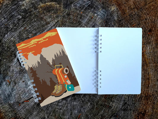 Notebook with illustration of hiking boots and a backpack