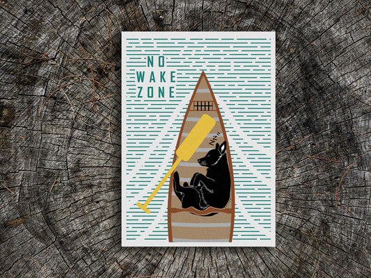 Art print of a black dog sleeping in a canoe with text No Wake Zone