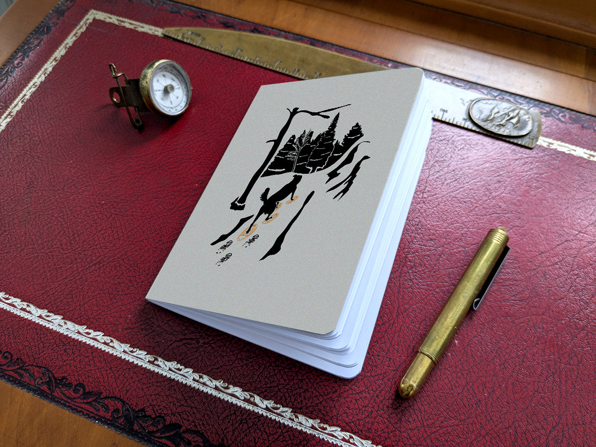 Notebook with illustration of a dog snowshoeing on a red desk.