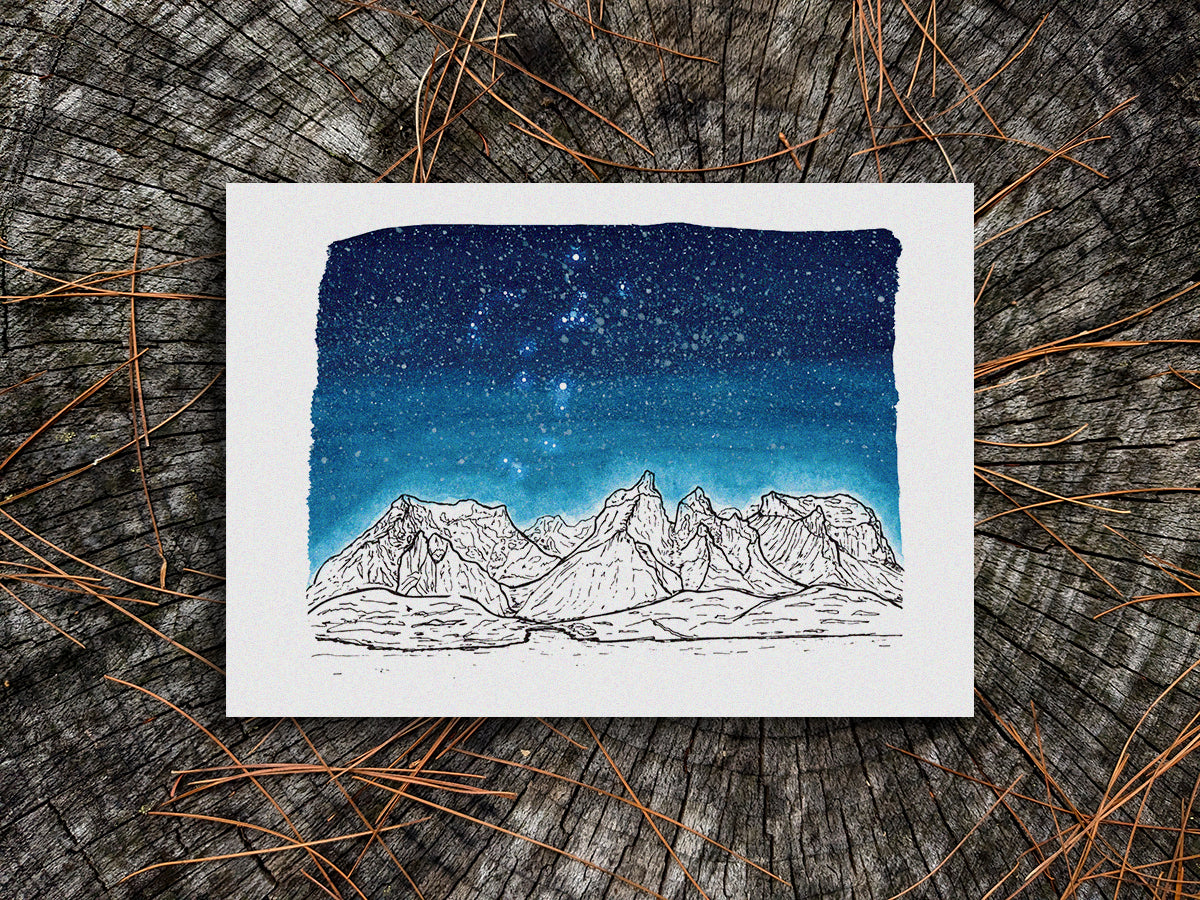 Art print of black and white mountains and a dark blue star filled sky