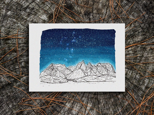 Art print of black and white mountains and a dark blue star filled sky