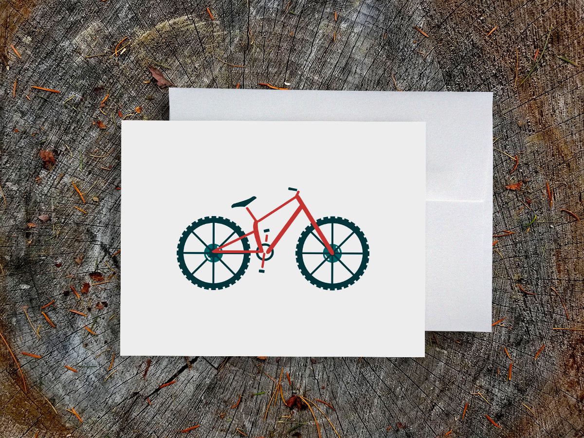 Greeting card with a red mountain bike with basket with wood background