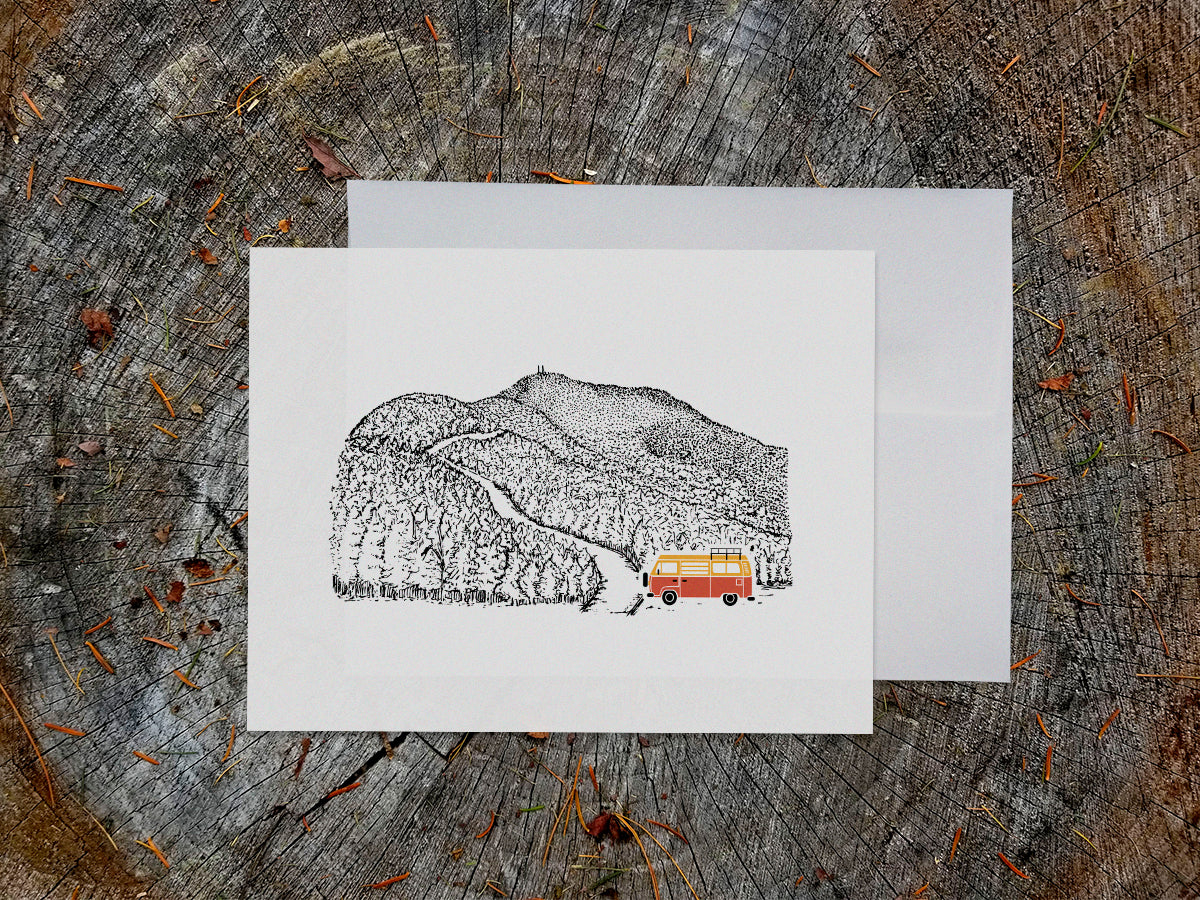 Greeting card with image of a mountain road and an orange and yellow campervan.