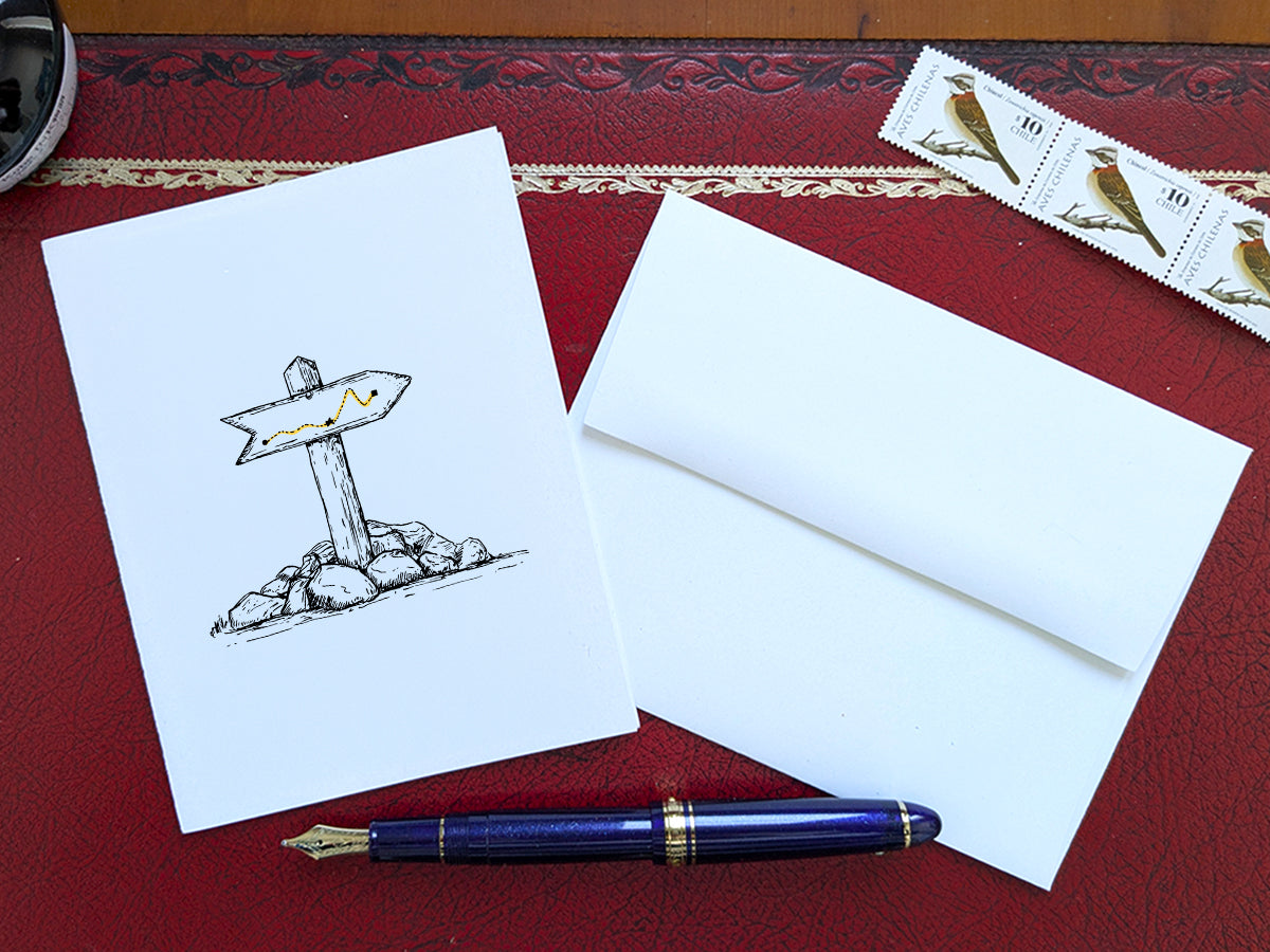 White card with a black ink drawing of a trail marker on a red surface with a pen, envelope and stamp.