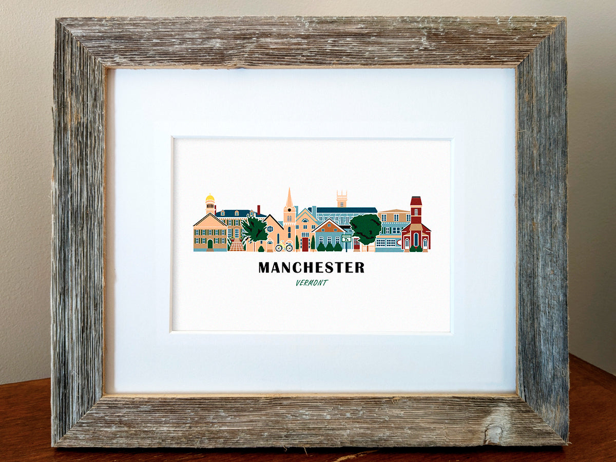 Framed art print of buildings arranged in a skyline with the text Manchester Vermont