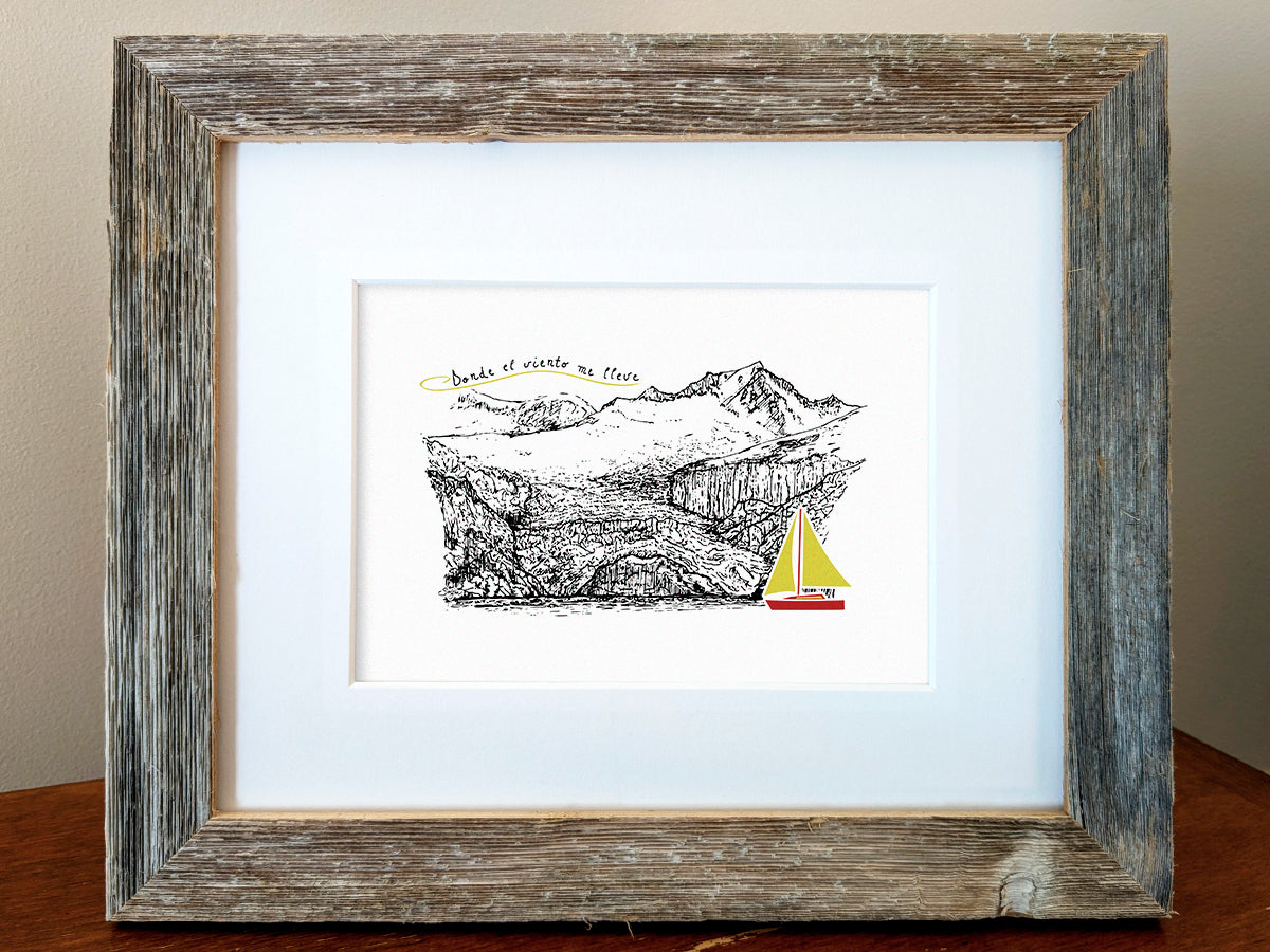 Framed art print of a red and yellow sailboat with mountains in the background and the text Donde el viento me lleve.