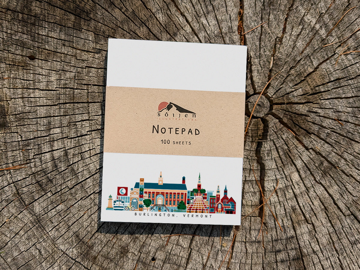 Notepad with illustration of Burlington, Vermont buildings in skyline on a wood surface