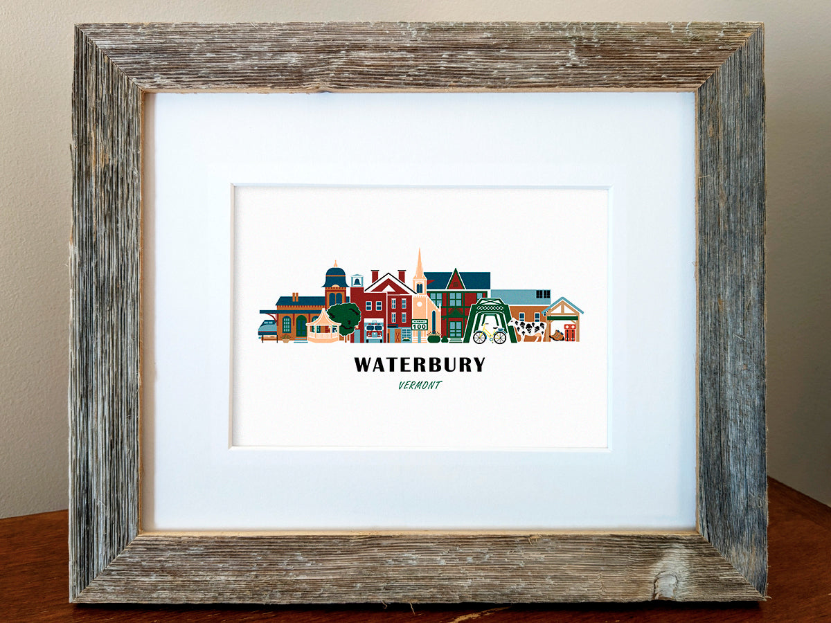 Framed art print of buildings arranged in a skyline with the text Waterbury Vermont