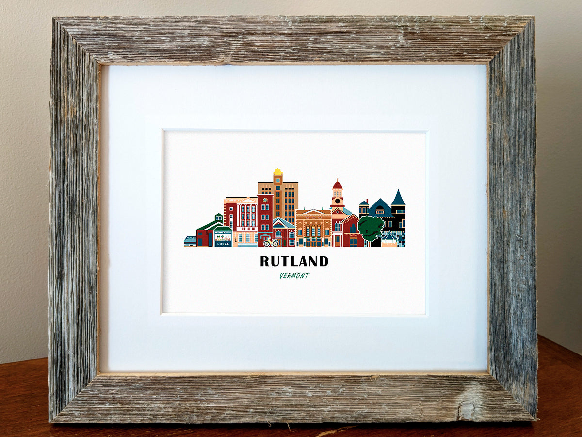 Framed art print of buildings arranged in a skyline with the text Rutland Vermont