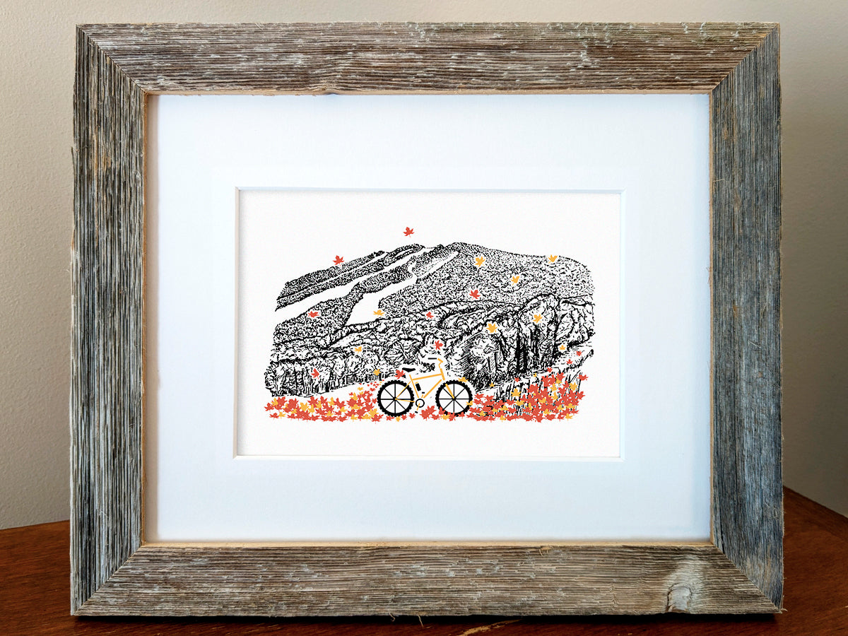 Framed art print with bicycle, leaves, and mountain illustration