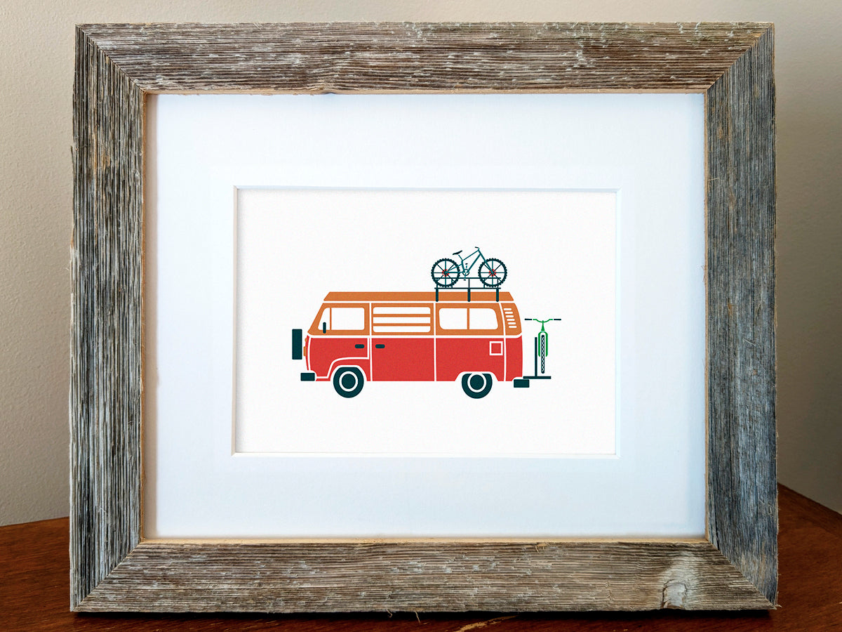 Framed art print of a red and orange van transporting 2 bicycles