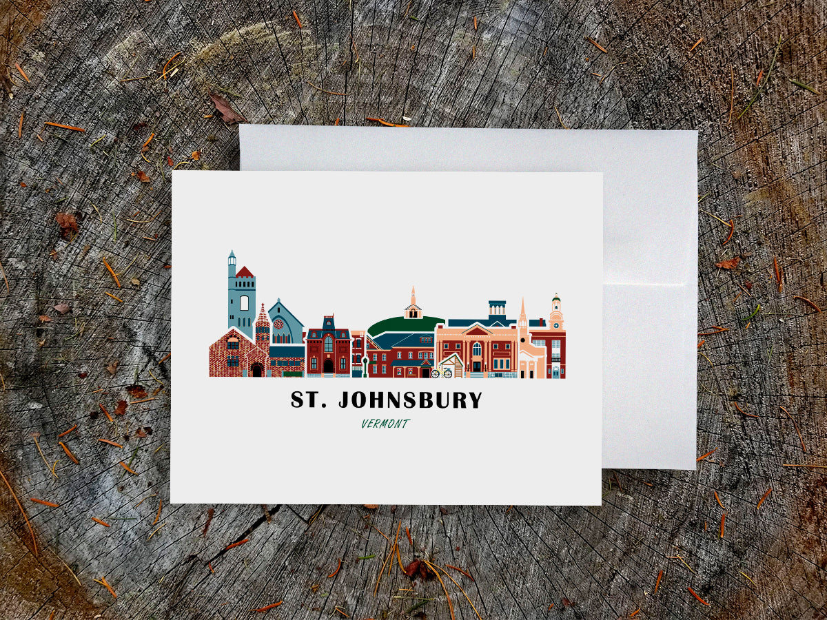 Greeting card with image of buildings arranged in a city skyline with the text St. Johnsbury Vermont