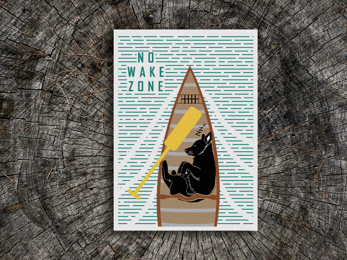 Art print of a black dog sleeping in a canoe with text No Wake Zone