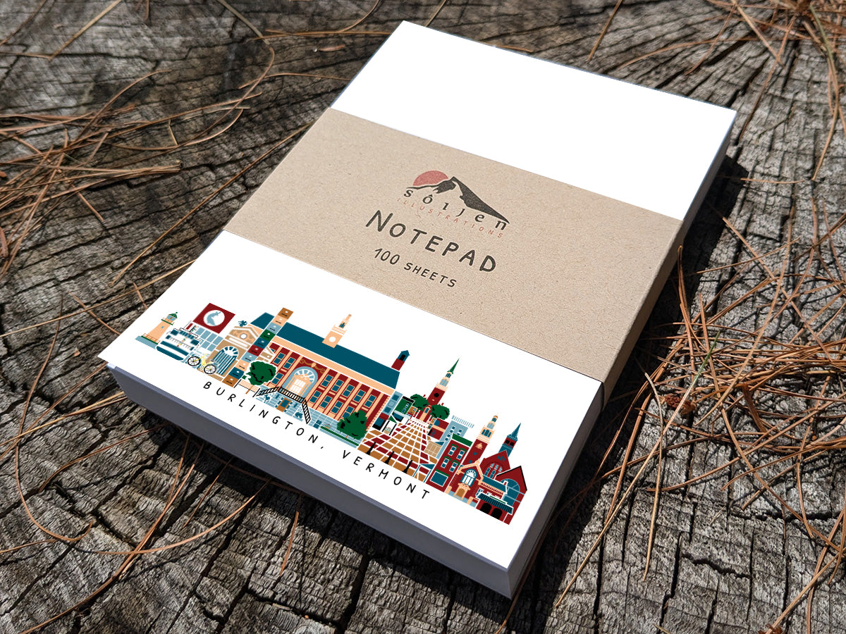 Notepad with illustration of Burlington, Vermont buildings in skyline on a wood surface