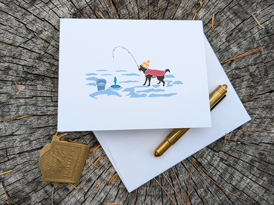 Greeting card with image of a dog with a winter hat and sweater ice fishing.