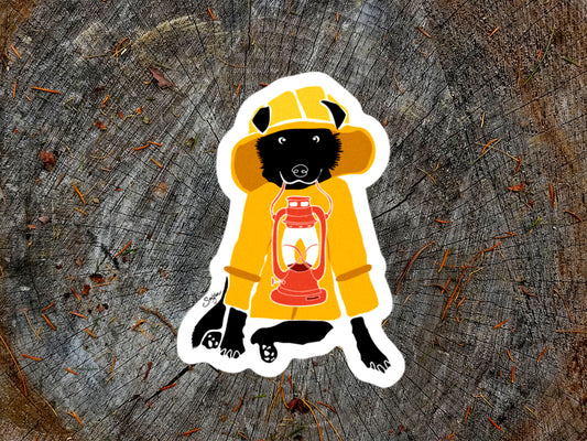 Sitcker with dog in a yellow jacket and hat holding a red lantern
