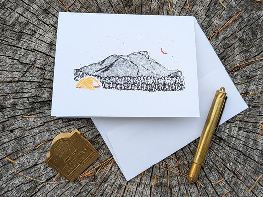 Greeting card with an image of a mountain and bright yellow tent under a starry sky.