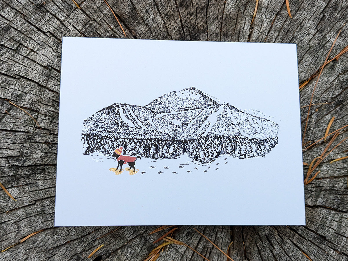 Greeting card with image of a mountain with ski trails and dog snowshoeing.