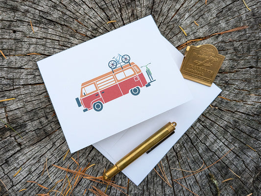 Greeting card with image of camper van with two bikes.