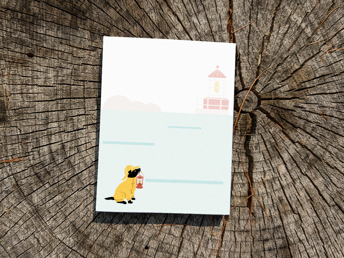 Notepad with an illustration of a dog in yellow hat and jacket holding a red lantern on a wood surface.