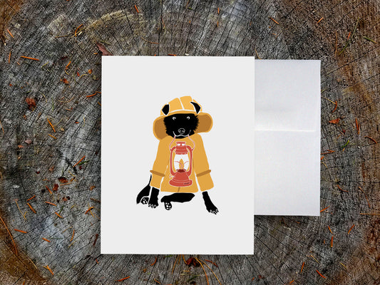 Greeting card with image of a dog with a yellow fisherman jacket holding a lantern.