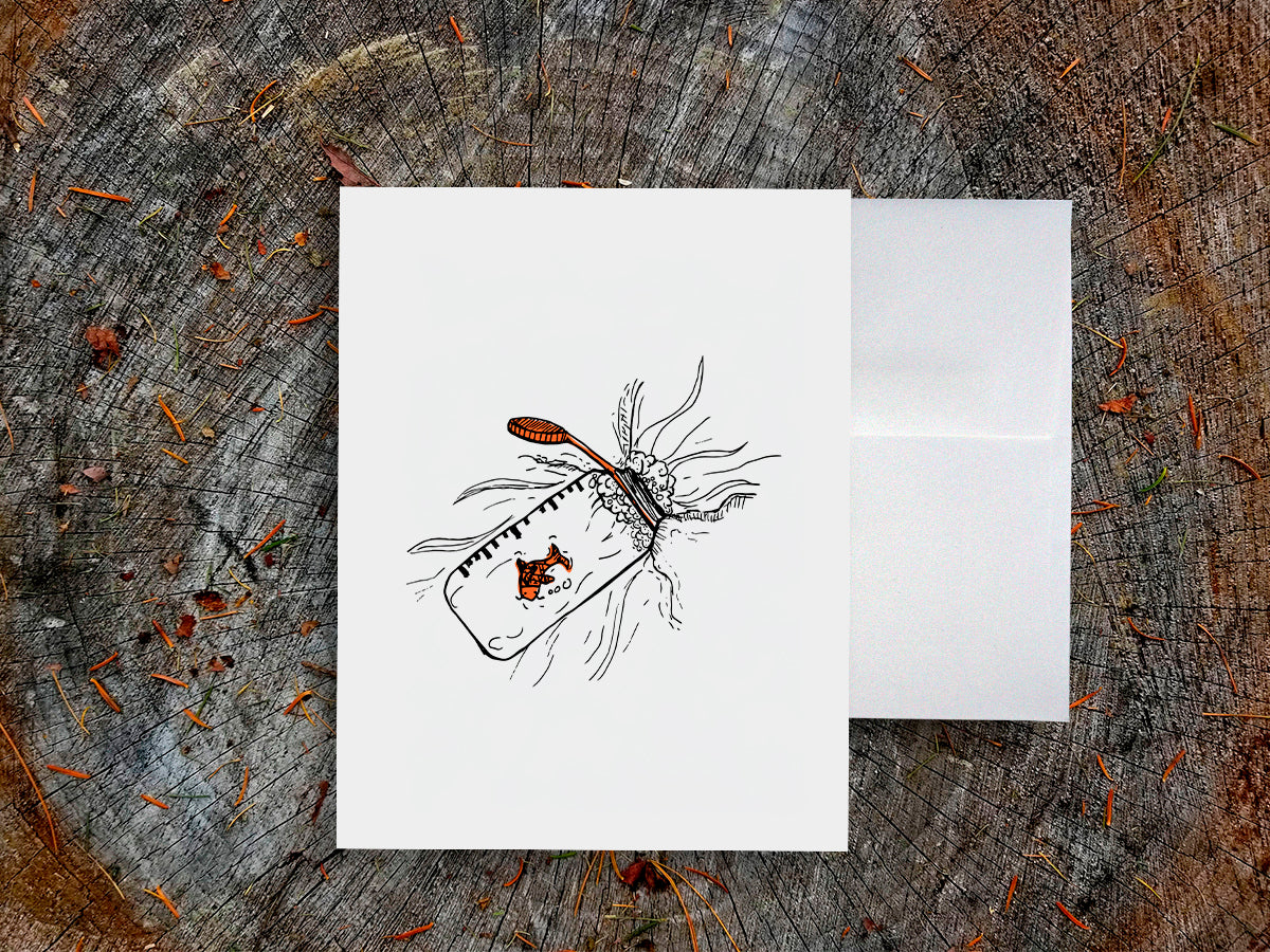 White card with a black ink drawing of a water bottle with red fish on a wooden surface.