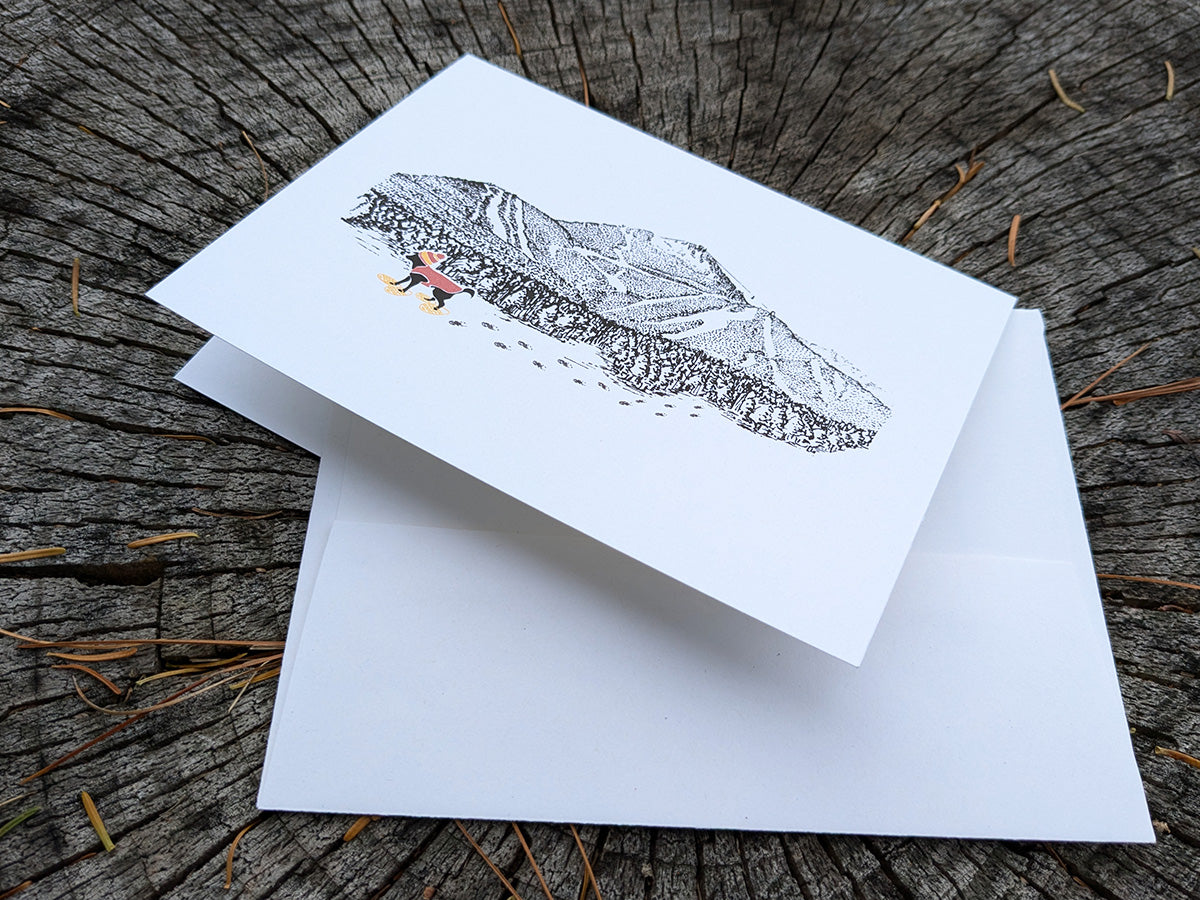 Greeting card with image of a mountain with ski trails and dog snowshoeing.