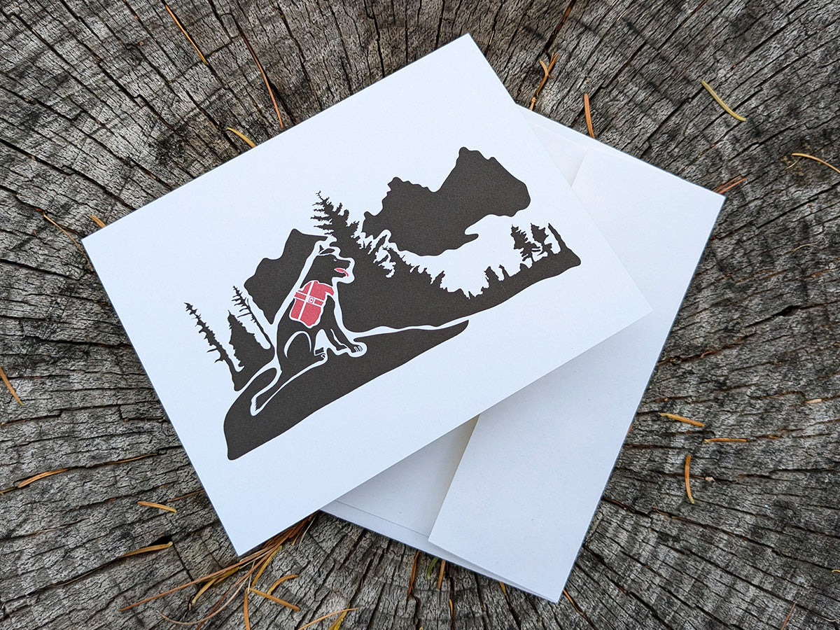 Greeting card with dog hiking in the mountains with envelope.