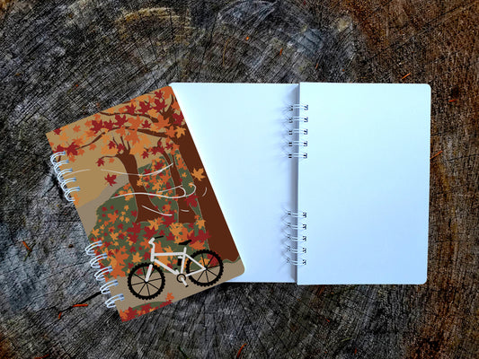 Notebook with a bicycle design on a wooden surface